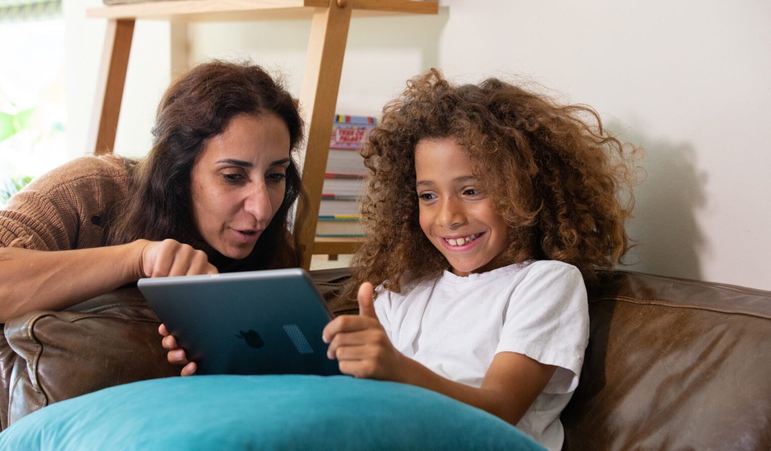 mother showing her daughter something on an ipad