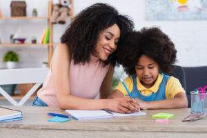 mother helping her daughter with math homework