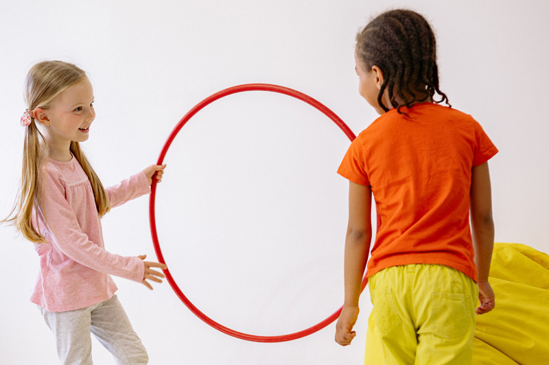 Children playing with a circle hoop