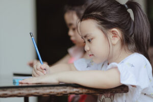 Young girl drawing shapes