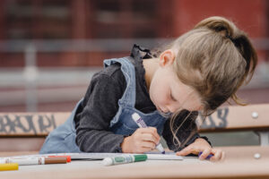Girl drawing shapes with pens