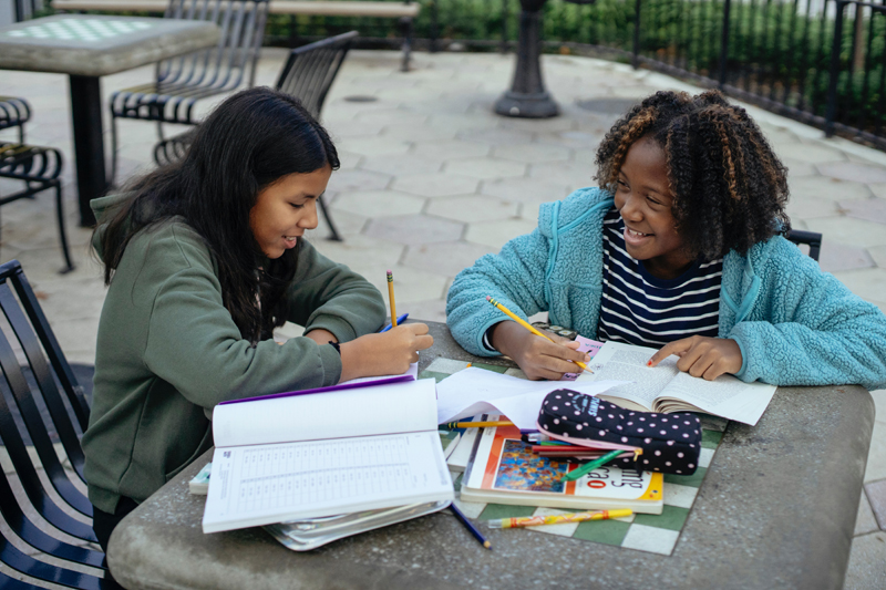 Two girls studying outside