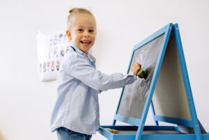 Young girl writing on a blackboard