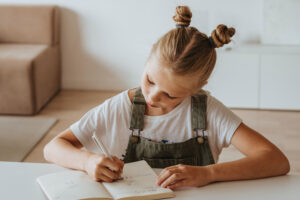 Girl writing in a book