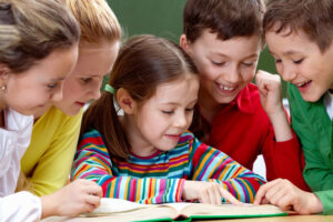 School kids reading- a book together